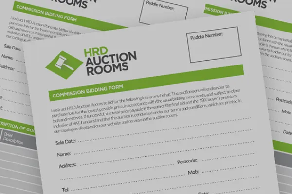 Overlapping HRD Auction Rooms bidding forms with white sheets, green header, paddle-number box, and fields for sale date, name, address, email.