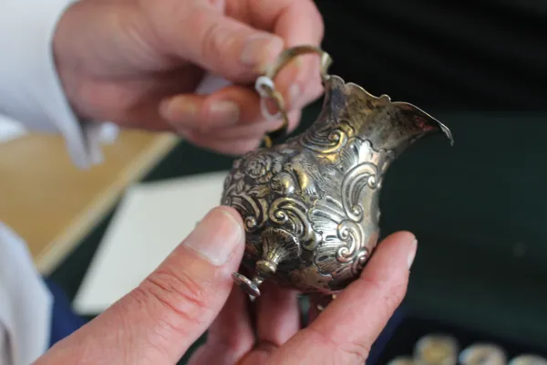 An appraiser inspecting an item for valuation.