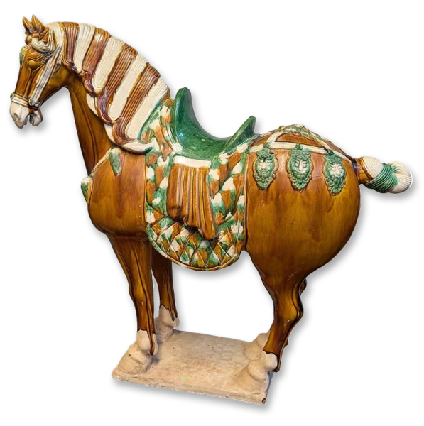 Brown ceramic horse figurine with a green saddle, striped cream mane, and a green-and-white diamond-pattern blanket on a beige base.